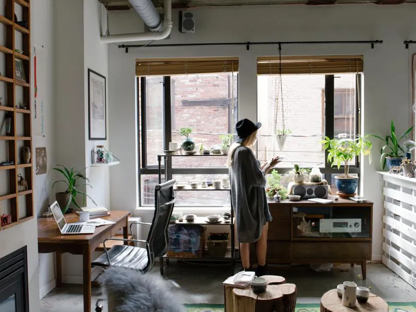 A person standing in a bright studio office