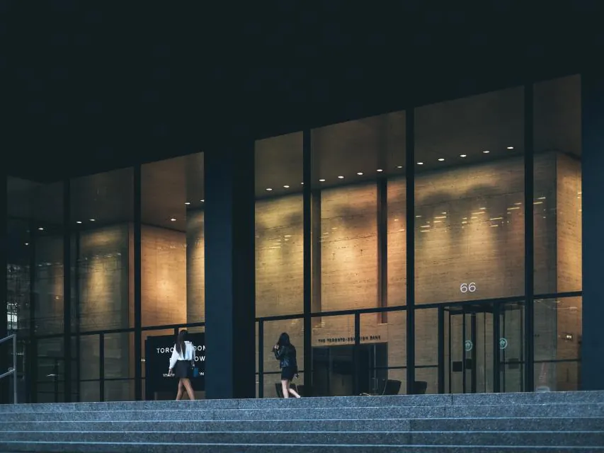Glass office building lobby lit at night