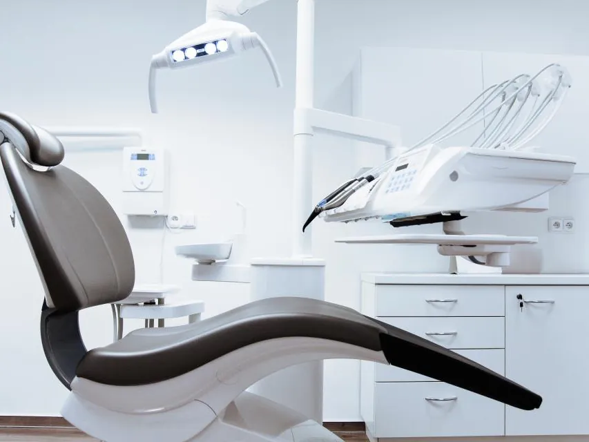 Dental chair and lights in a clean treatment room