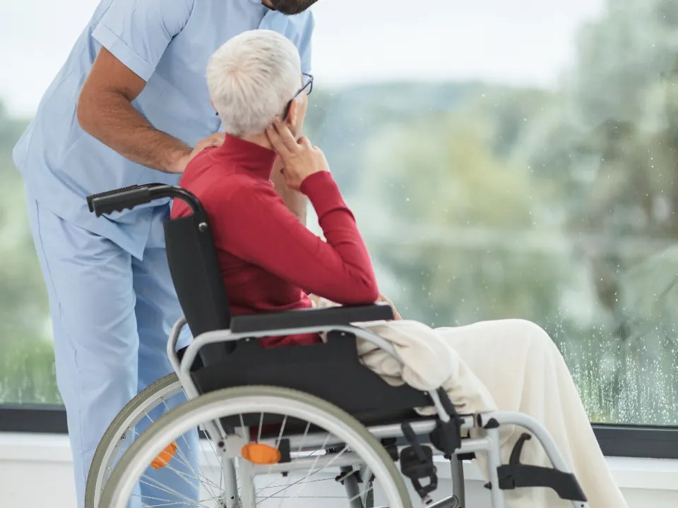 Support worker beside a woman in a wheelchair