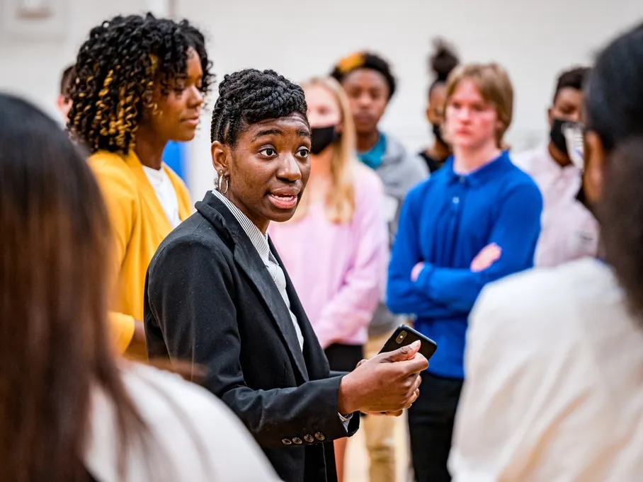 A group of young people in conversation at an event