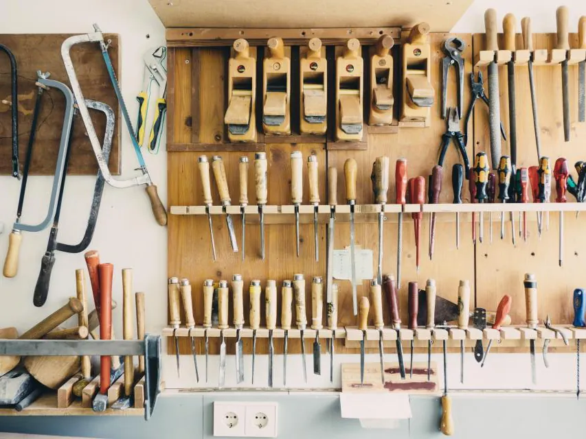 A workshop wall of hand tools, saws and chisels