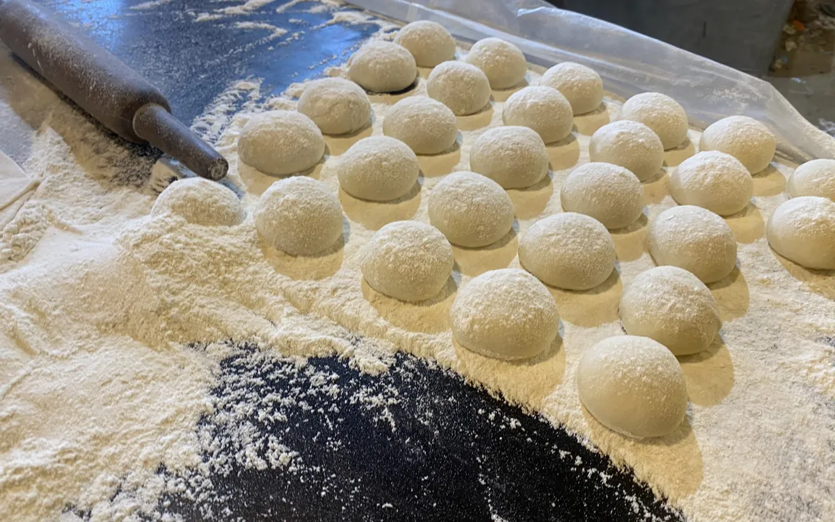 Deegballen op een met bloem bestoven werkblad
