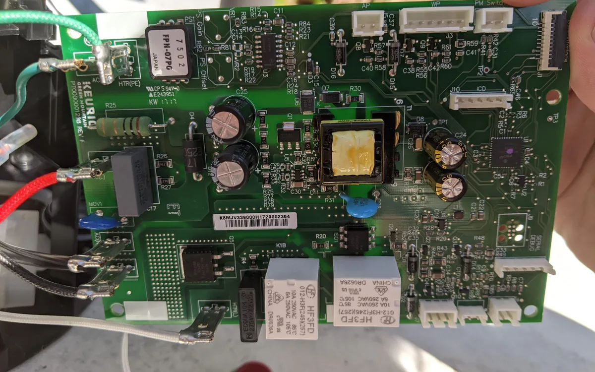 A hand holding a circuit board