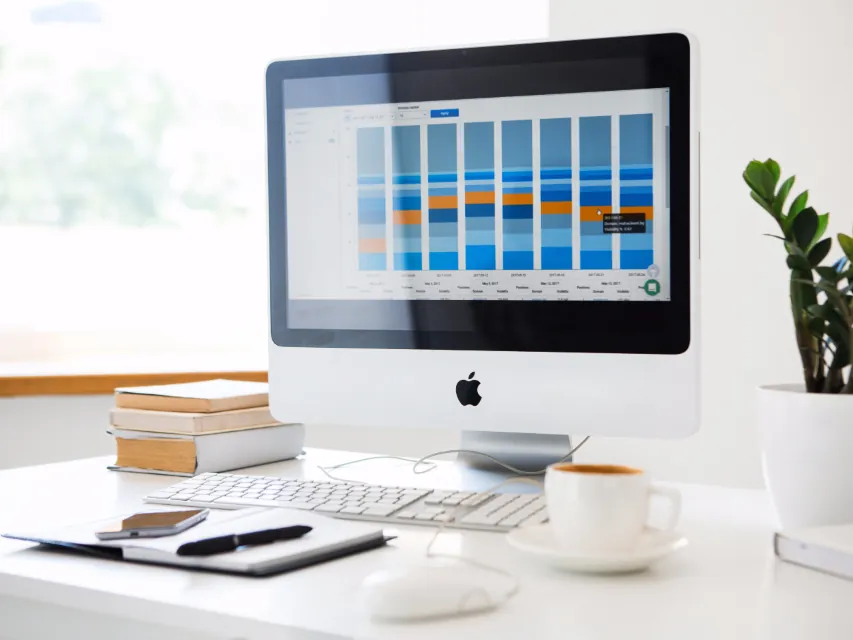 A desktop computer showing a dashboard on a white desk