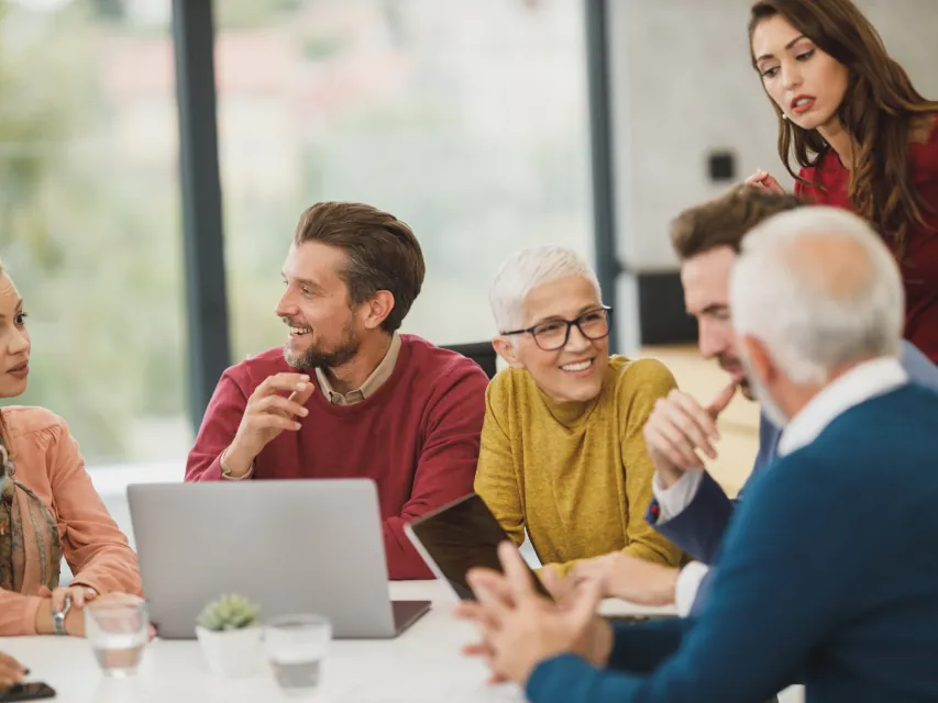 A team around a laptop in a meeting